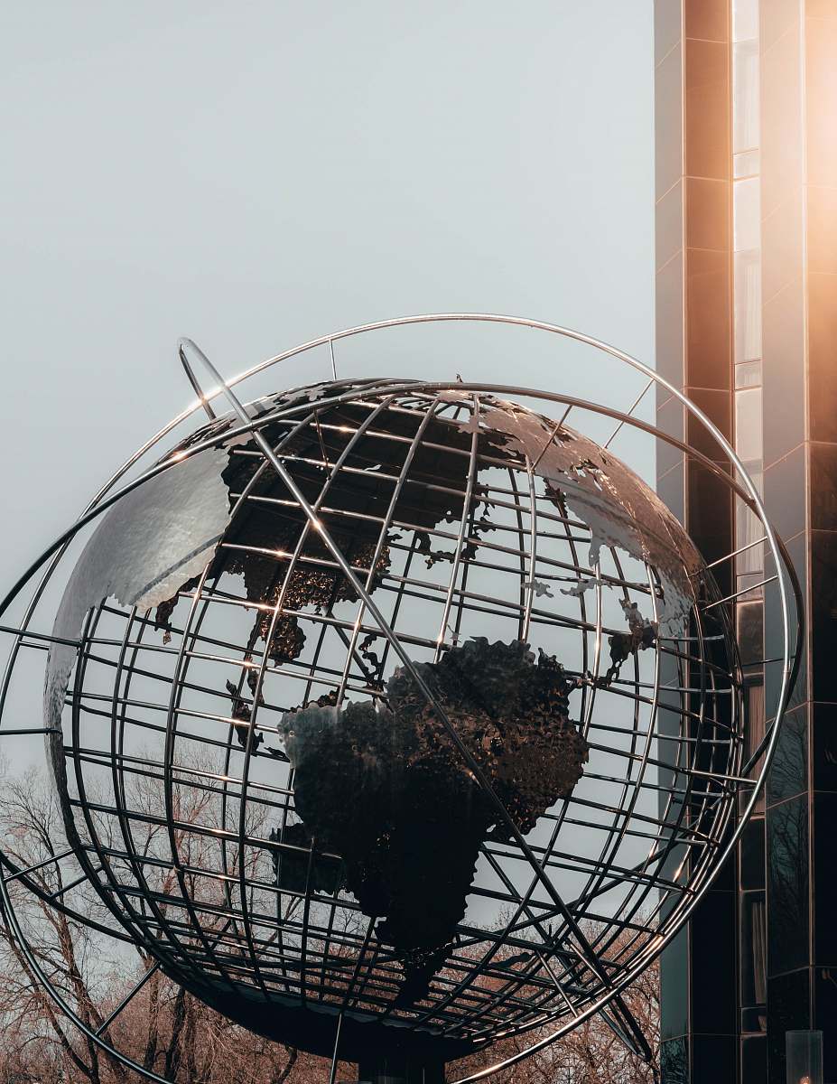 outer space gray sphere statue near building sphere